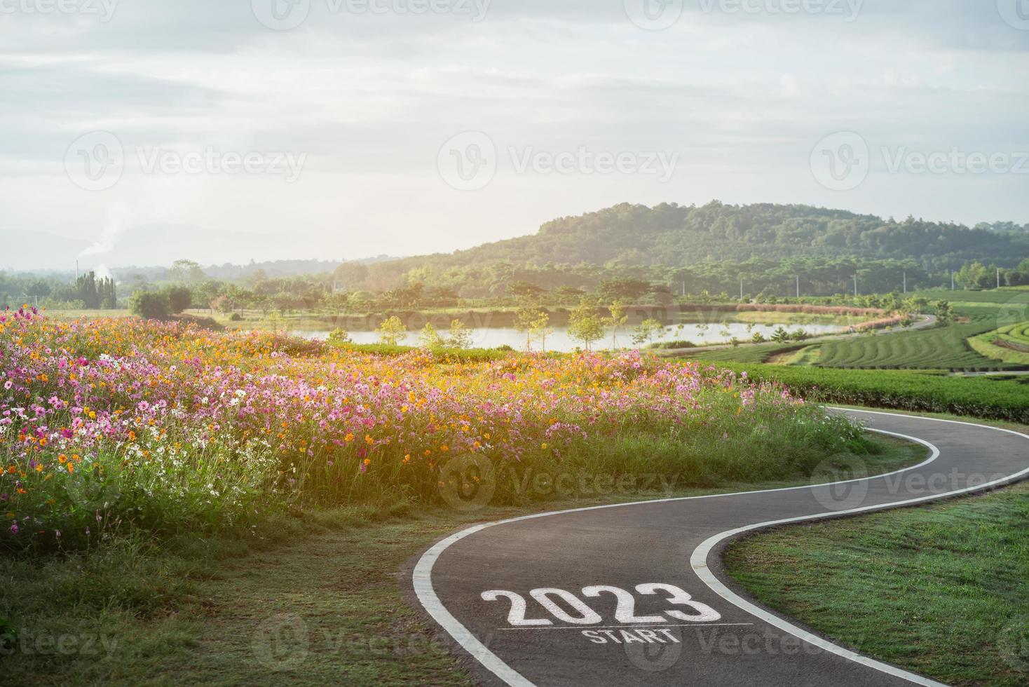 Happy new year 2023,2023 symbolizes the start of the new year. The letter start new year 2023 on the road in the nature fresh green tea farm mountain environment ecology or greenery wallpaper concept. photo