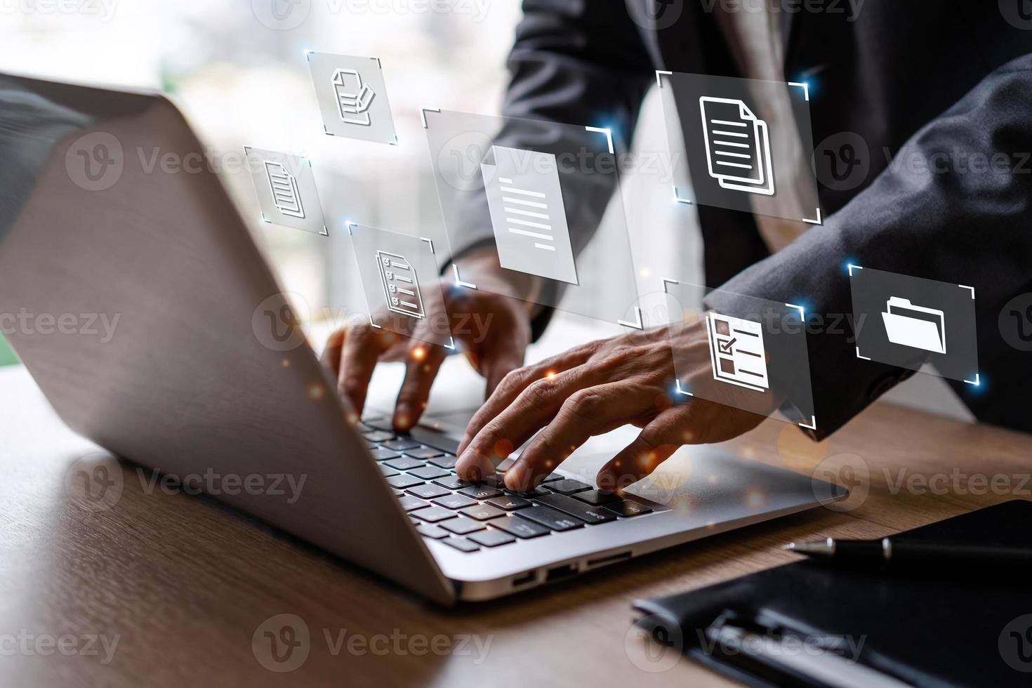 Businessman working and using a computer to manage online documentation database and digital file storage in the office, Document Management System concept photo