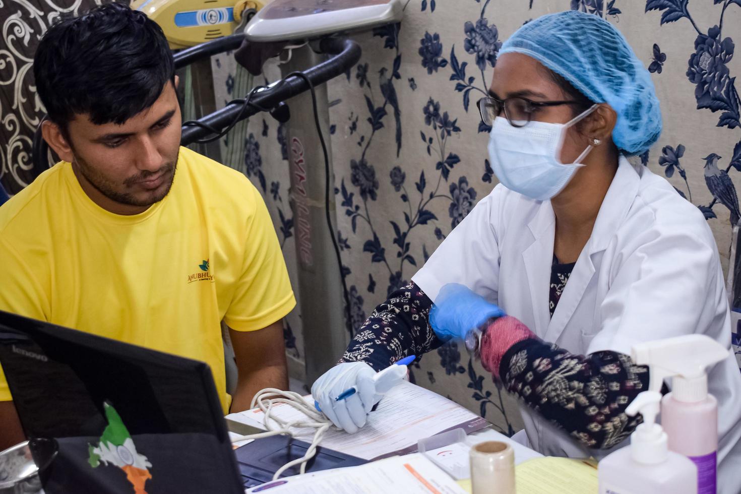 Delhi, India - November 19, 2022 -Close up of female dentist doing routine dental check-up to patient, Patient lying on chair at annual health check-up, Dentist doing dental check-up to patient photo