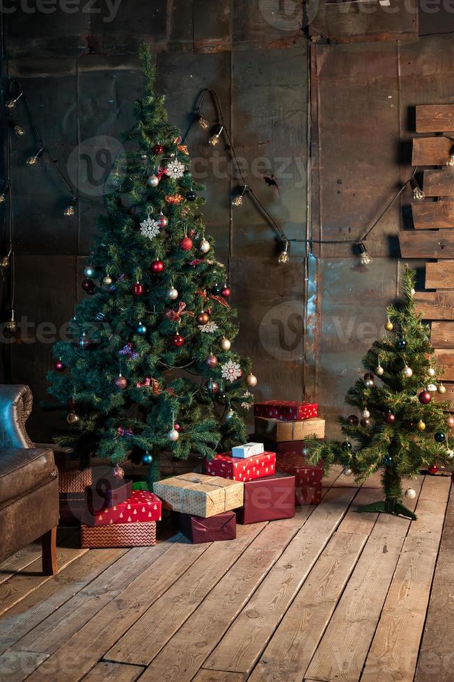 Winter home decor. Christmas tree in the interior against a wooden wall photo