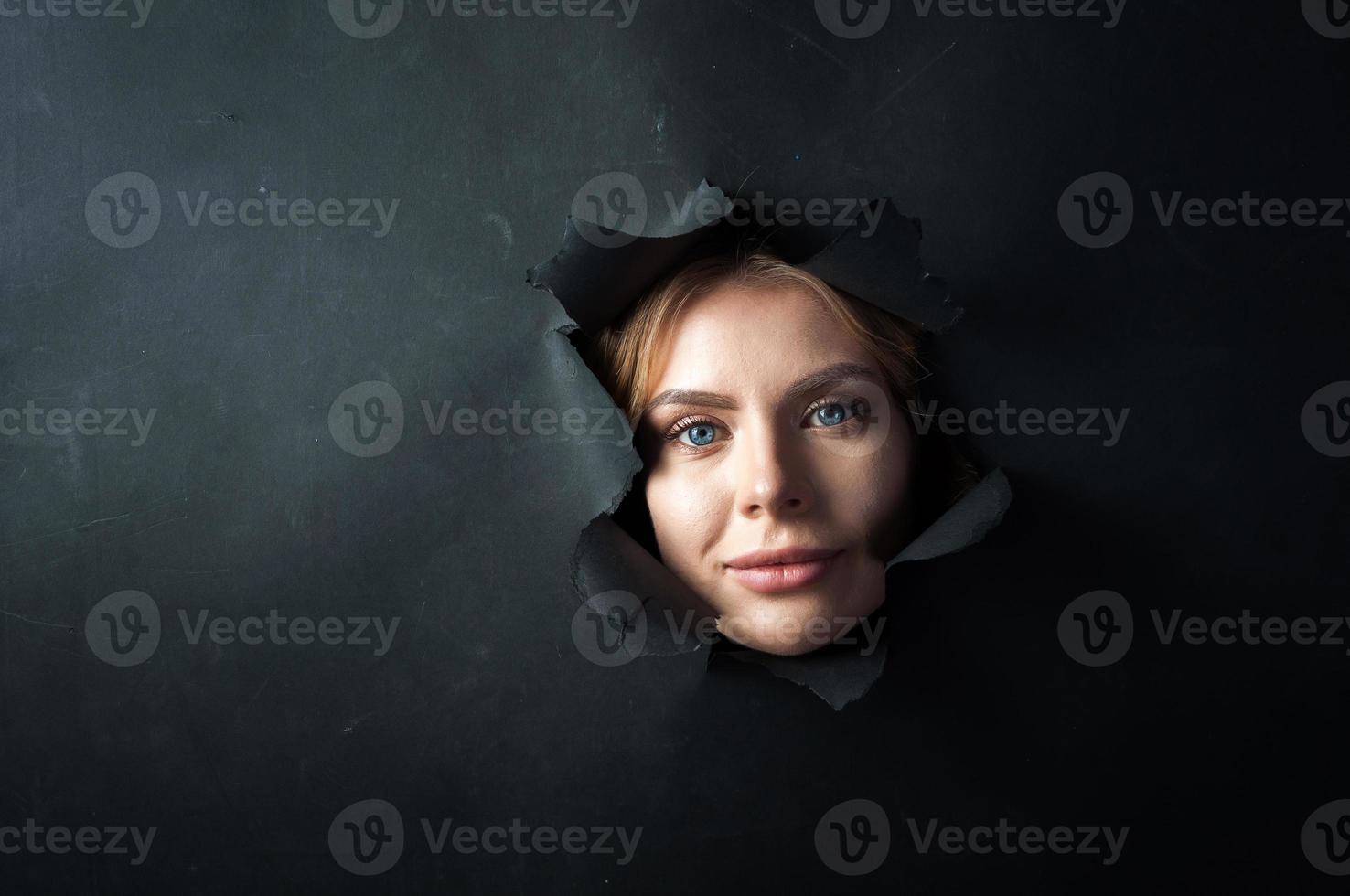 The girl's face appears on a black background. photo