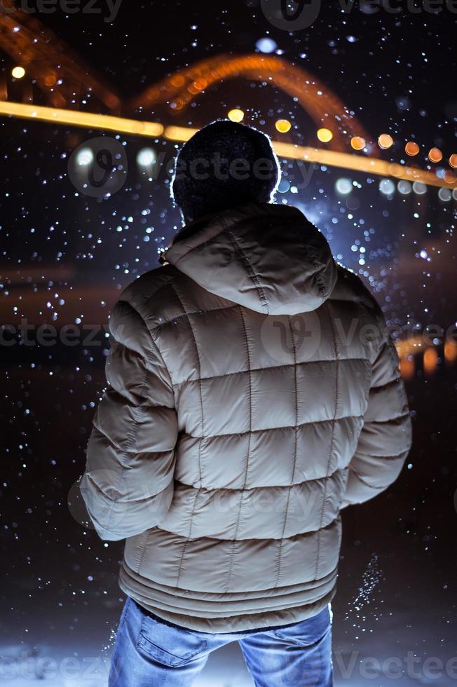 silhouette of a man on the background of falling snow in winter photo