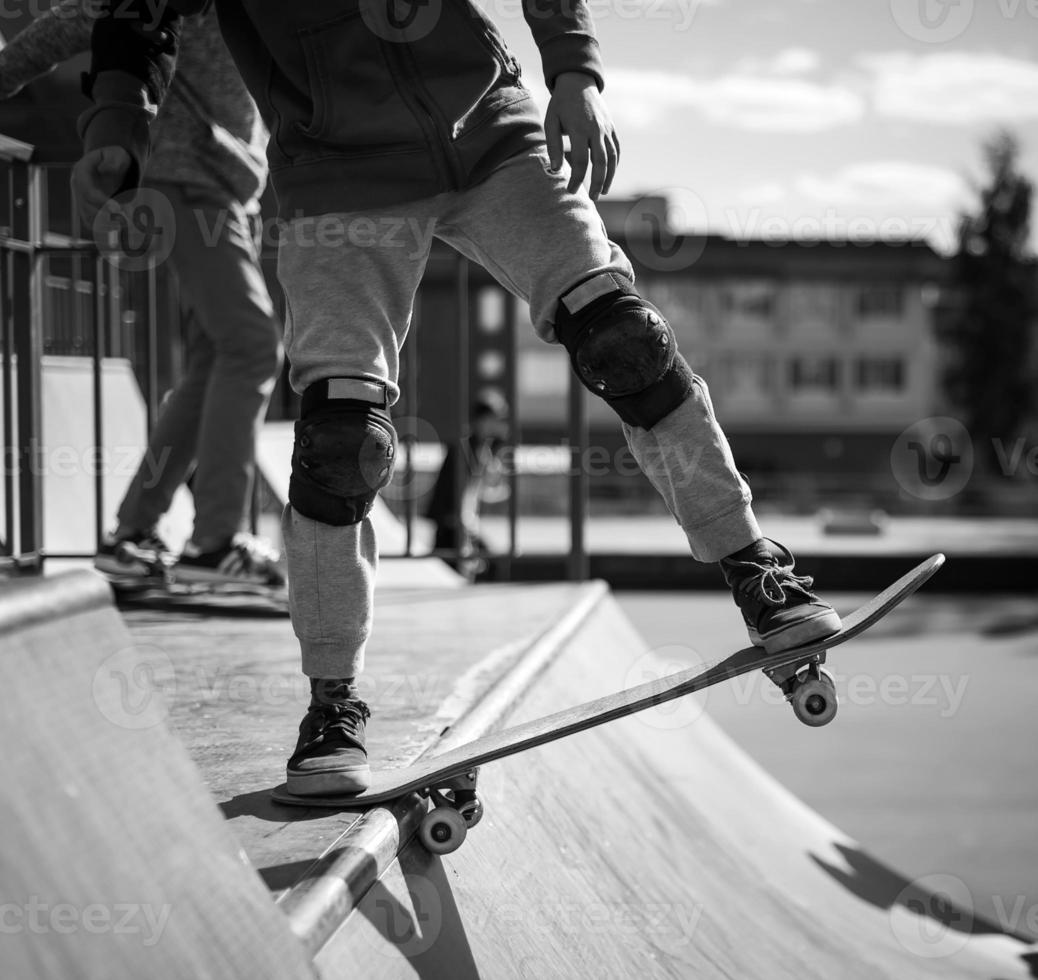 skateboarder does the trick with a jump on the ramp. Skateboarder flying in the air photo