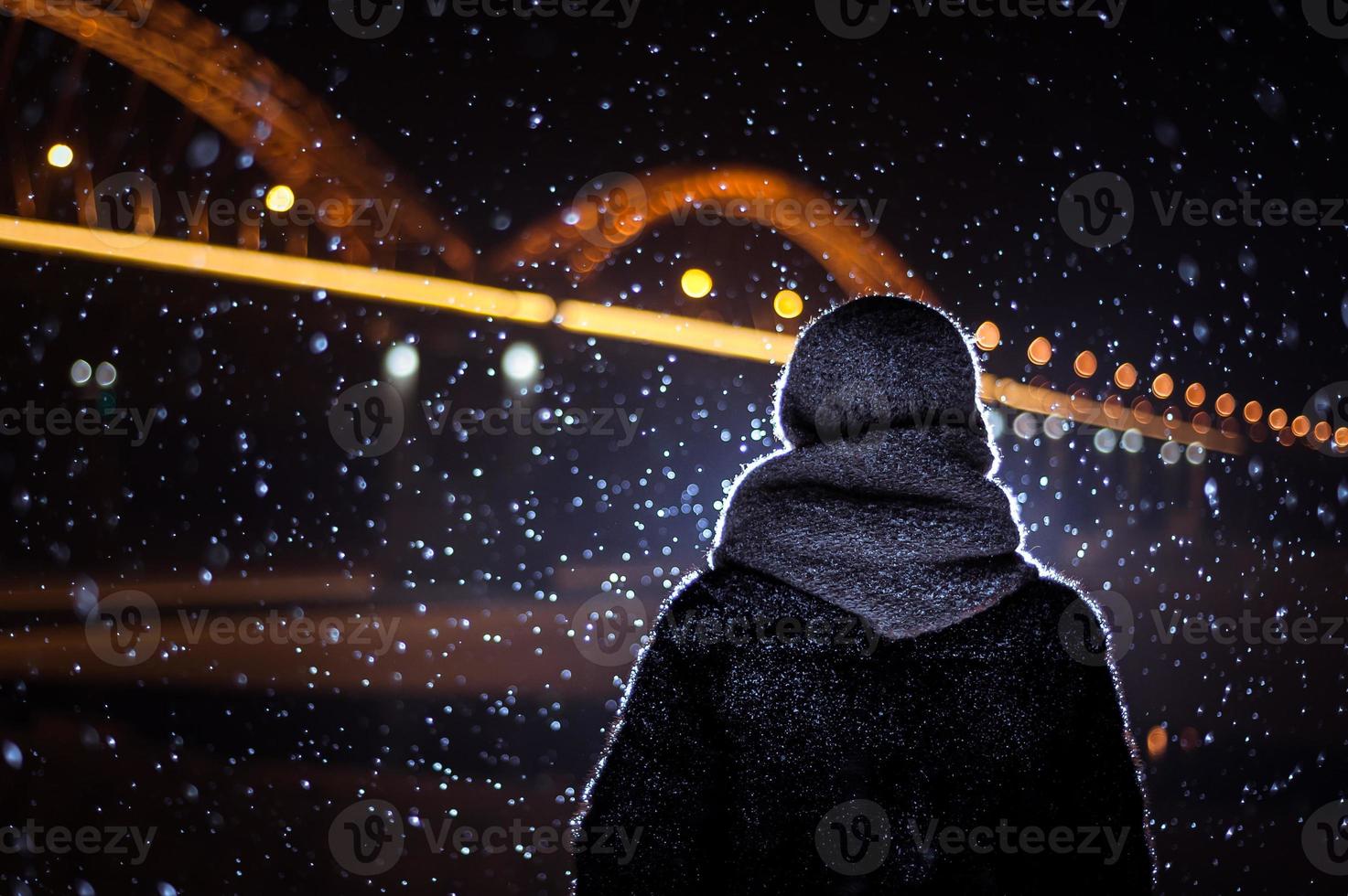 silhouette of a man on the background of falling snow in winter photo