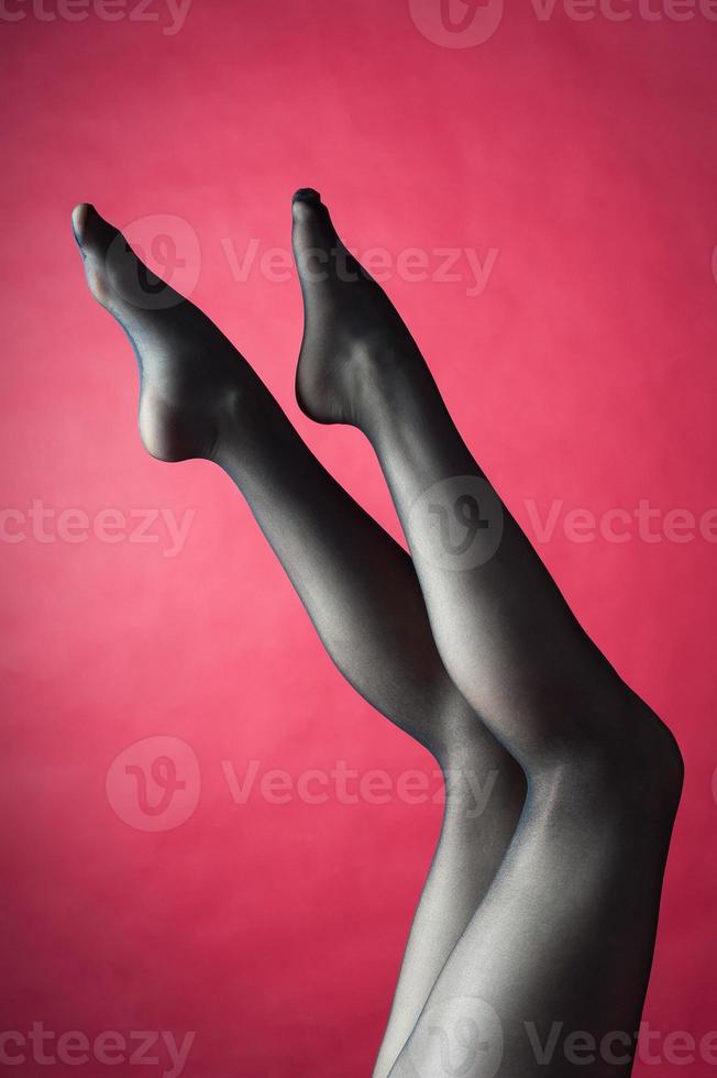 Legs of young caucasian woman in black tights photo