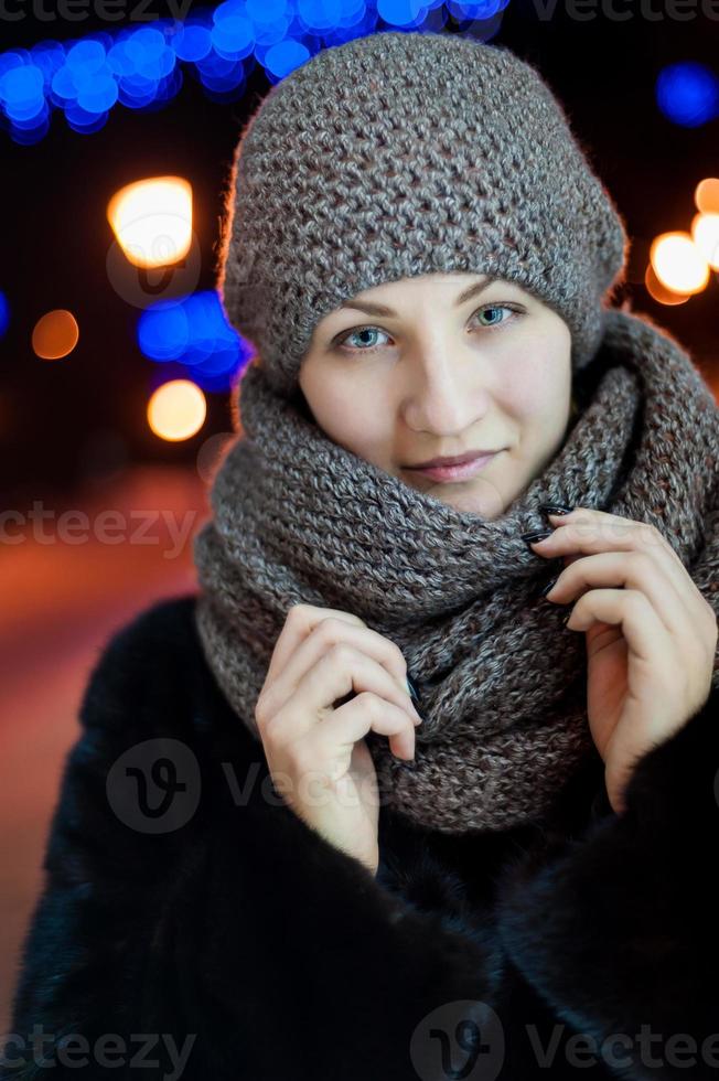 Portrait of a girl on the street in a scarf and hat photo