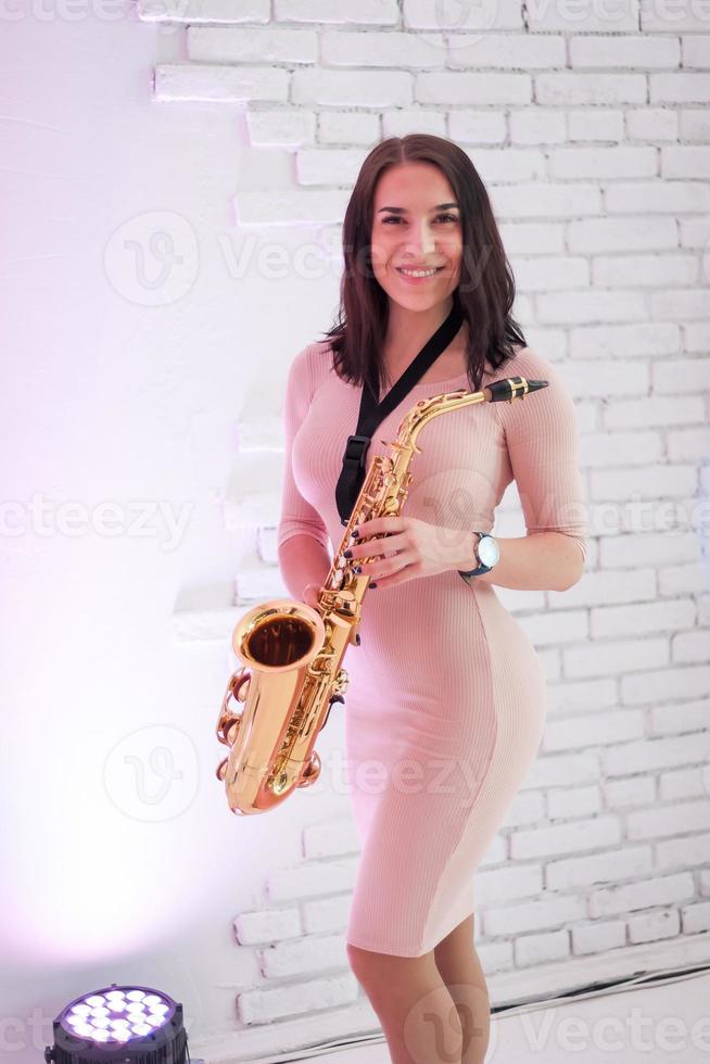 Beautiful girl playing saxophone photo