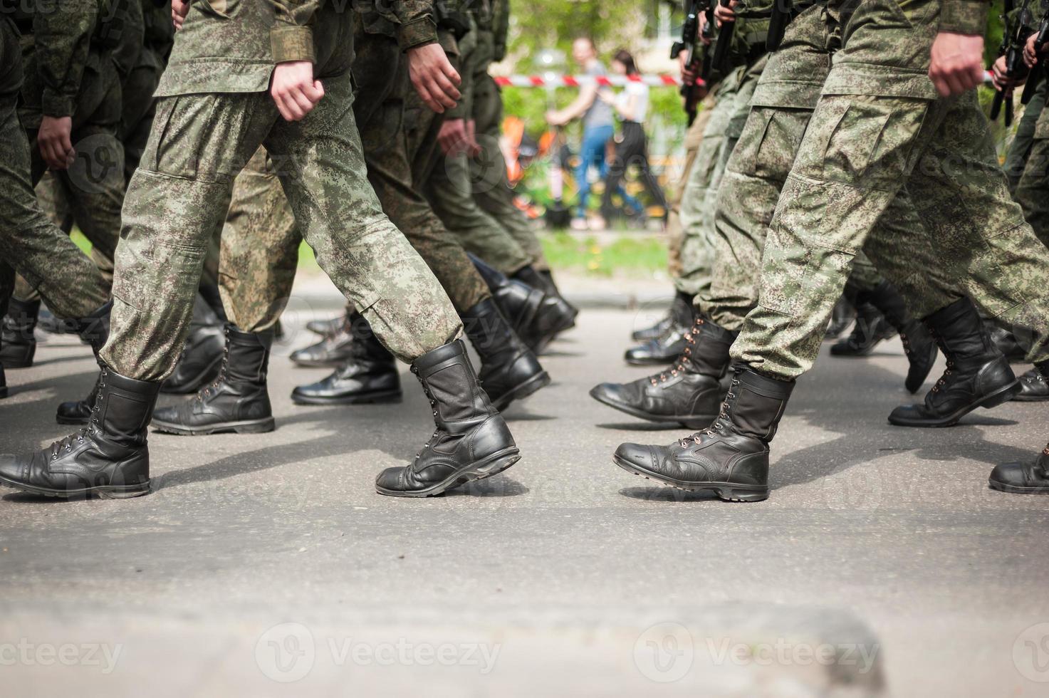 Marching soldiers in military boots photo