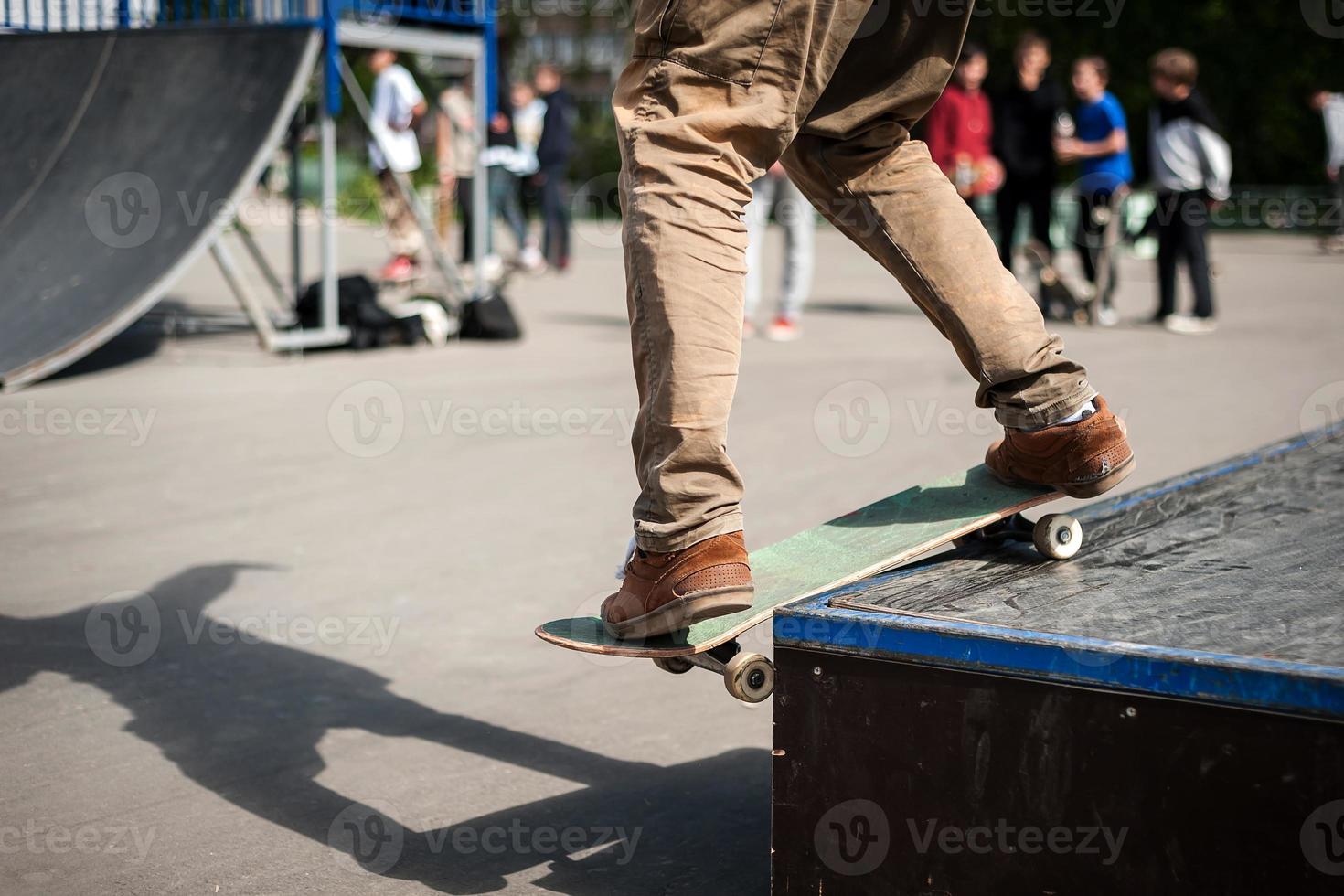 skateboarder does the trick with a jump on the ramp. Skateboarder flying in the air photo