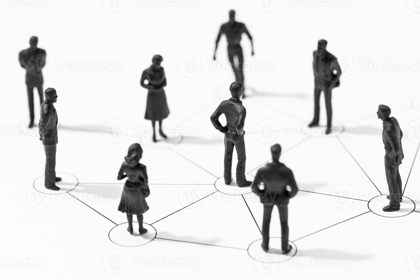 Group of Linked people figurines. Members connected with each other photo