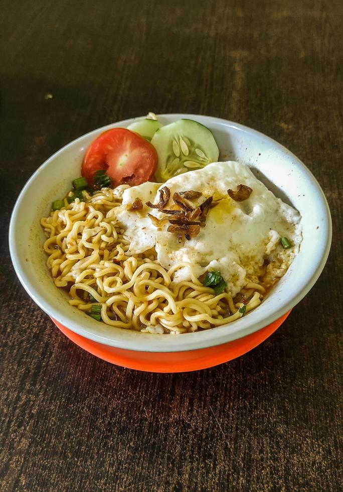 boiled noodle soup with eggs and complete toppings photo