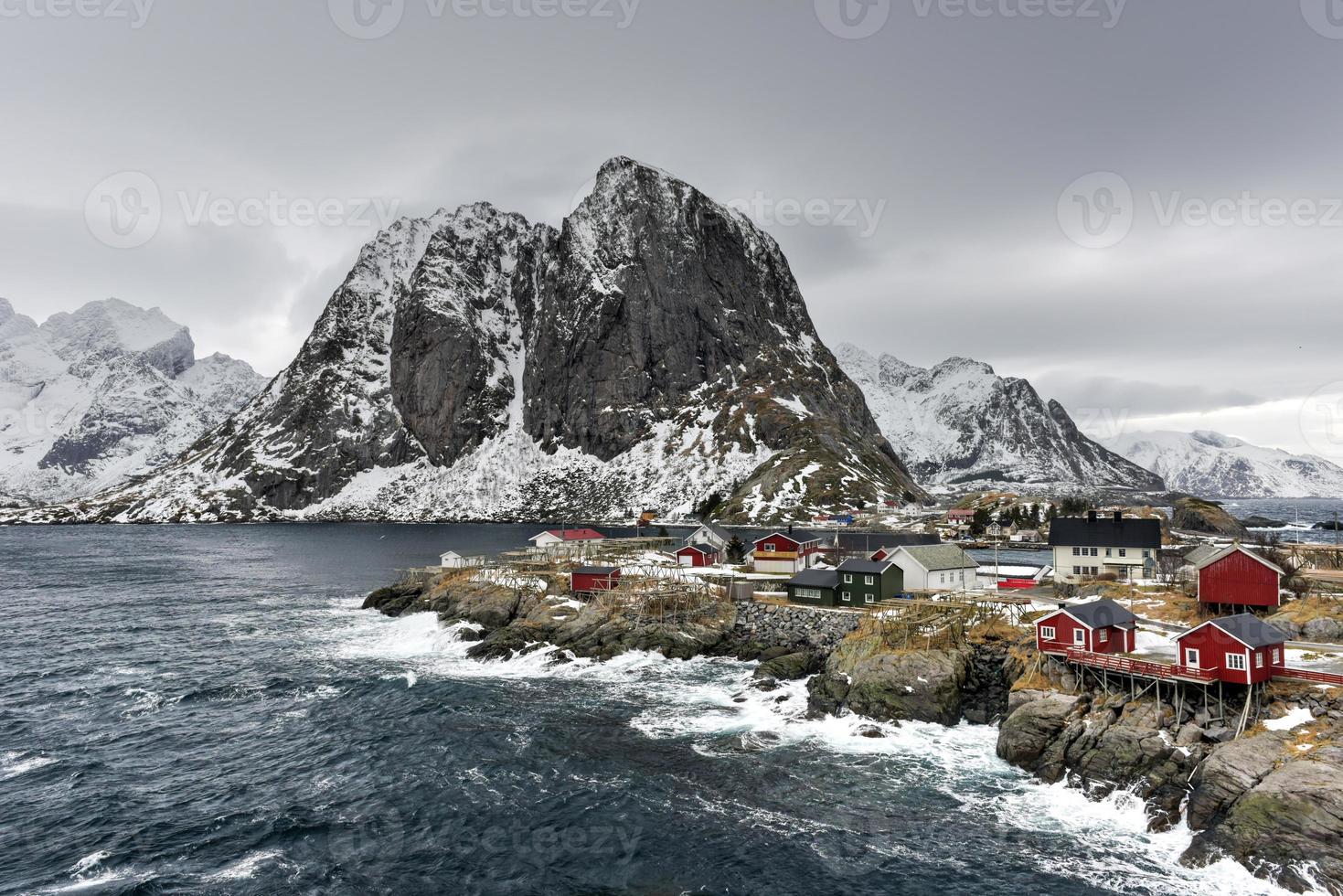 Fishing hut in the Hamnoy and Lilandstinden mountain peak in winter in Reine, Lofoten Islands, Norway. photo