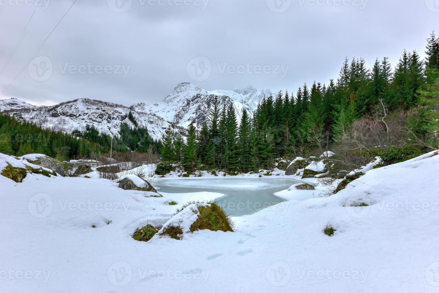 Storvatnet Lake in front of the landscape of the Lofoten mountains on the island Flakstadoy in the winter. photo