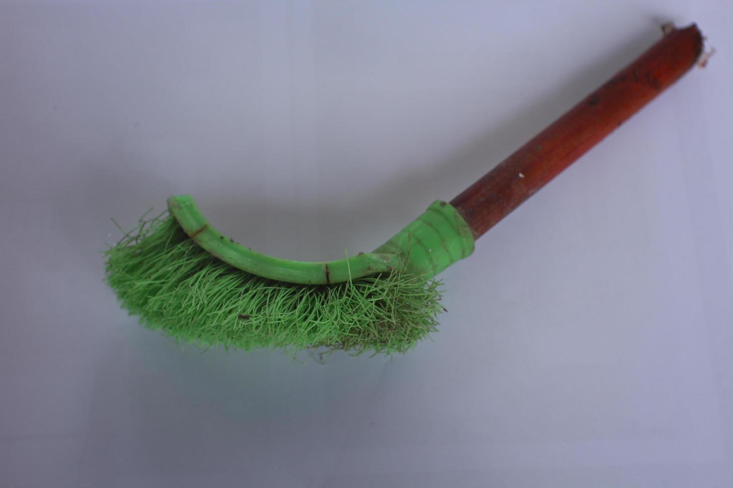 green toilet brush isolated on white background photo