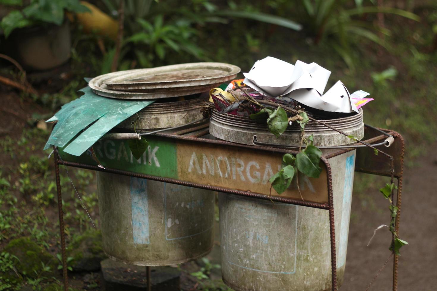 2 trash cans that have been damaged and are still in use. photo