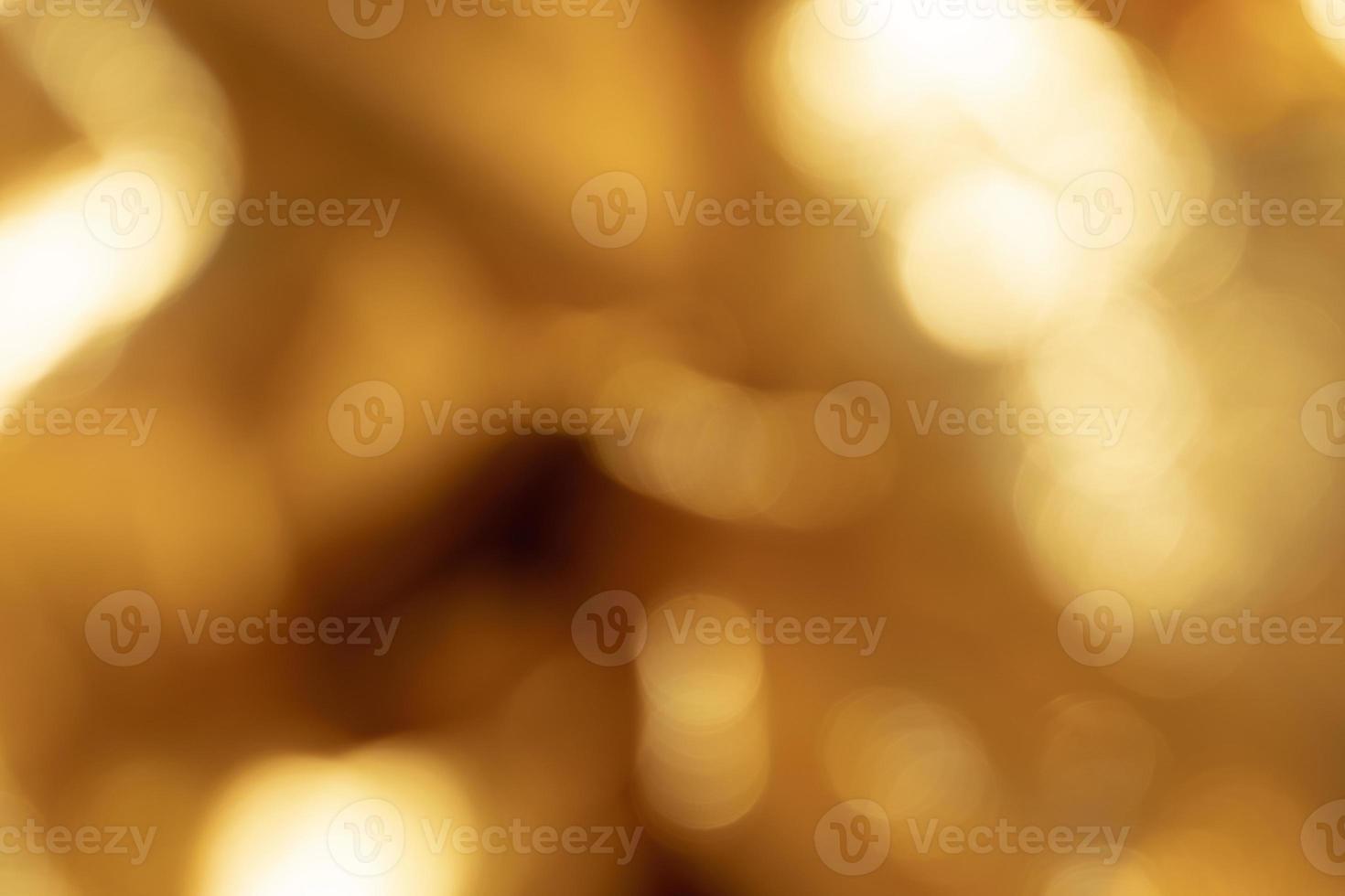 Abstract out of focus golden blurred metallic background photo