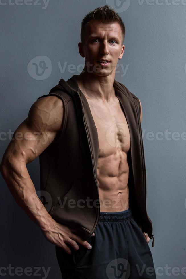 Portrait of young muscular man wearing vest photo