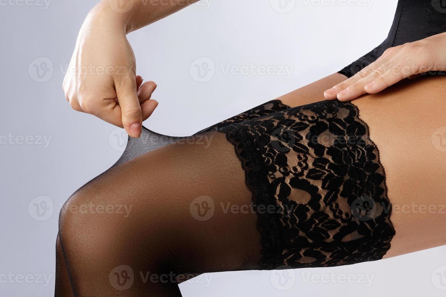 Female legs in black stockings photo