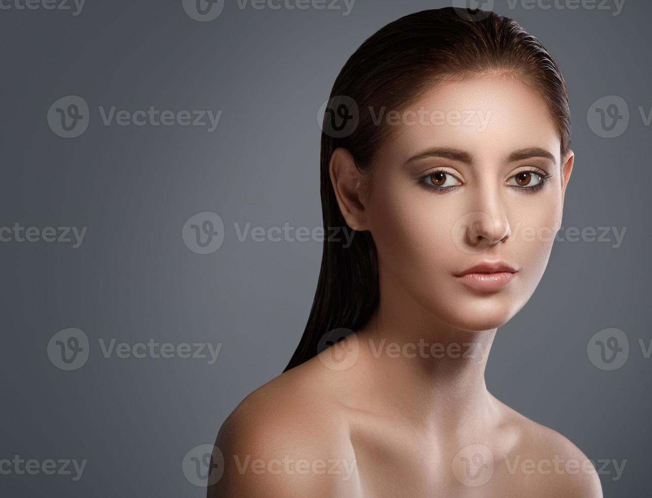 Portrait of beautiful brunette with wet hair photo