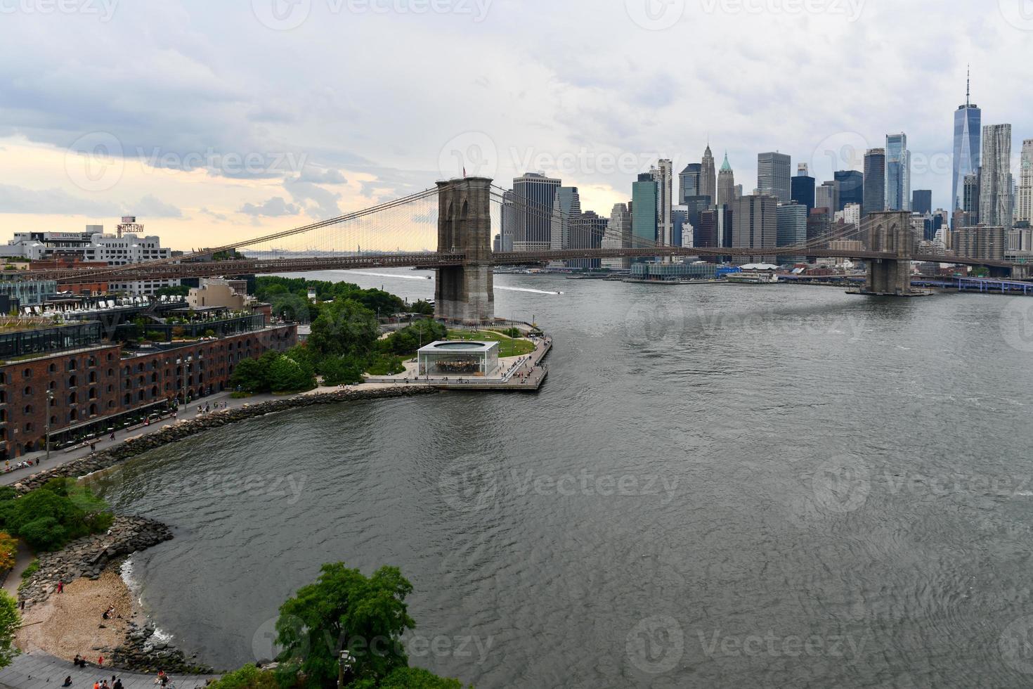 Panoramic view of the East River and the Brooklyn Bridge between Brooklyn and Manhattan in New York City. photo