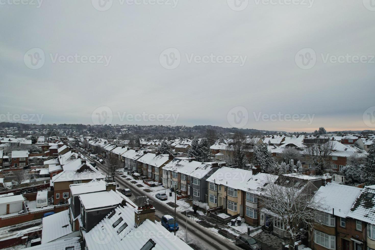 High angle view of Snow covered North Luton's landscape and Cityscape, Aerial Footage of Northern Luton City of England UK after Snow Fall. The 1st Snow Fall of this Winter of 2022 photo
