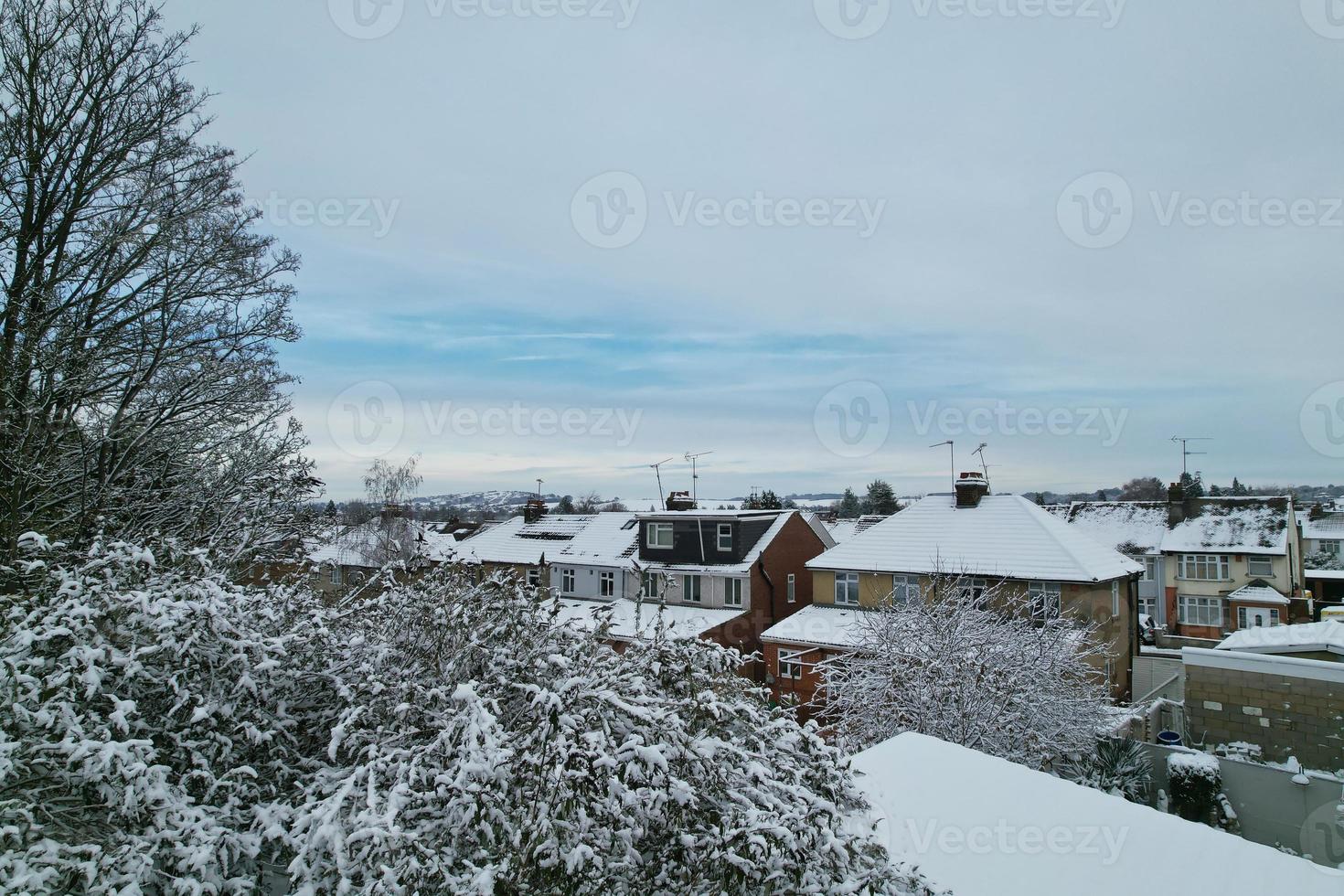 High angle view of Snow covered North Luton's landscape and Cityscape, Aerial Footage of Northern Luton City of England UK after Snow Fall. The 1st Snow Fall of this Winter of 2022 photo