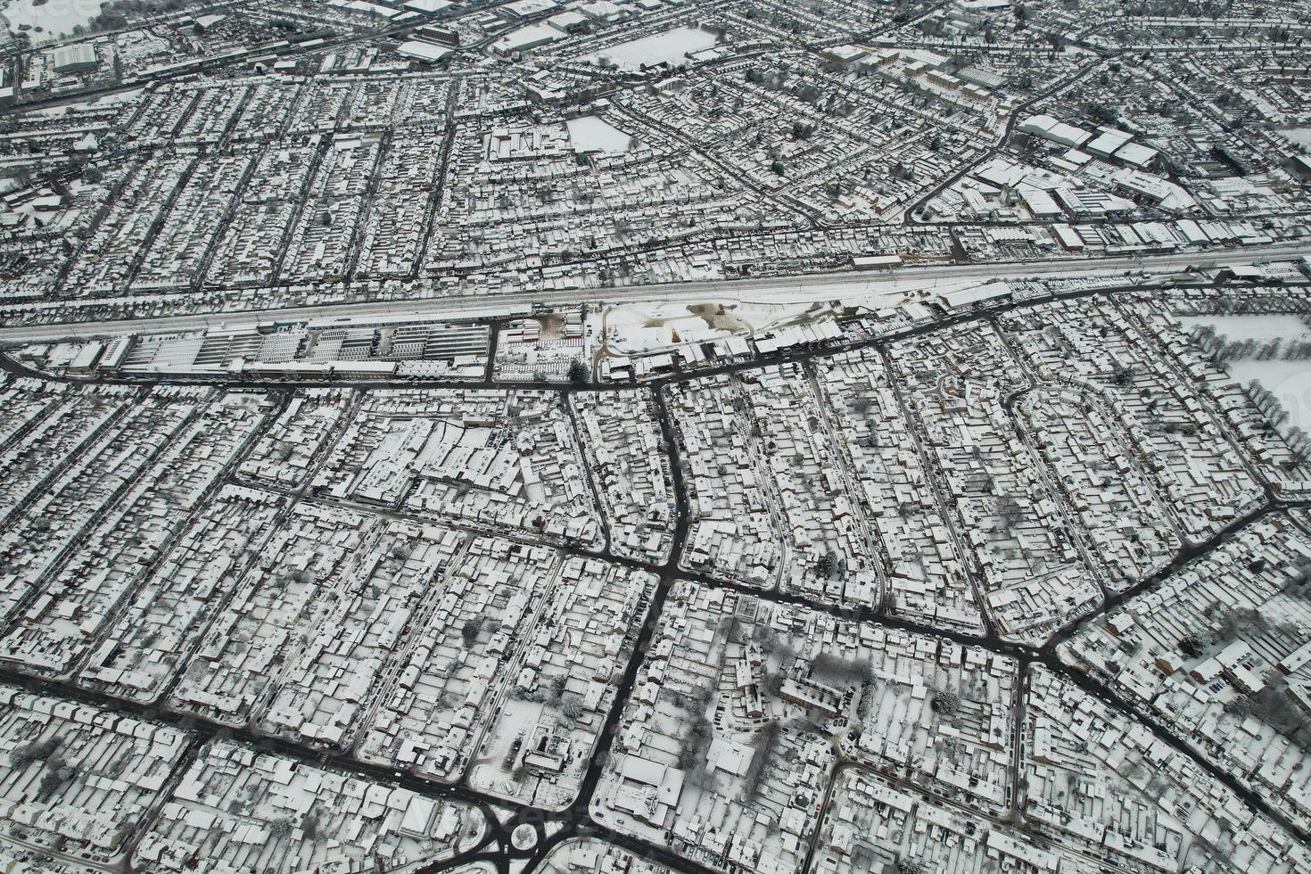 High angle view of Snow covered North Luton's landscape and Cityscape, Aerial Footage of Northern Luton City of England UK after Snow Fall. The 1st Snow Fall of this Winter of 2022 photo