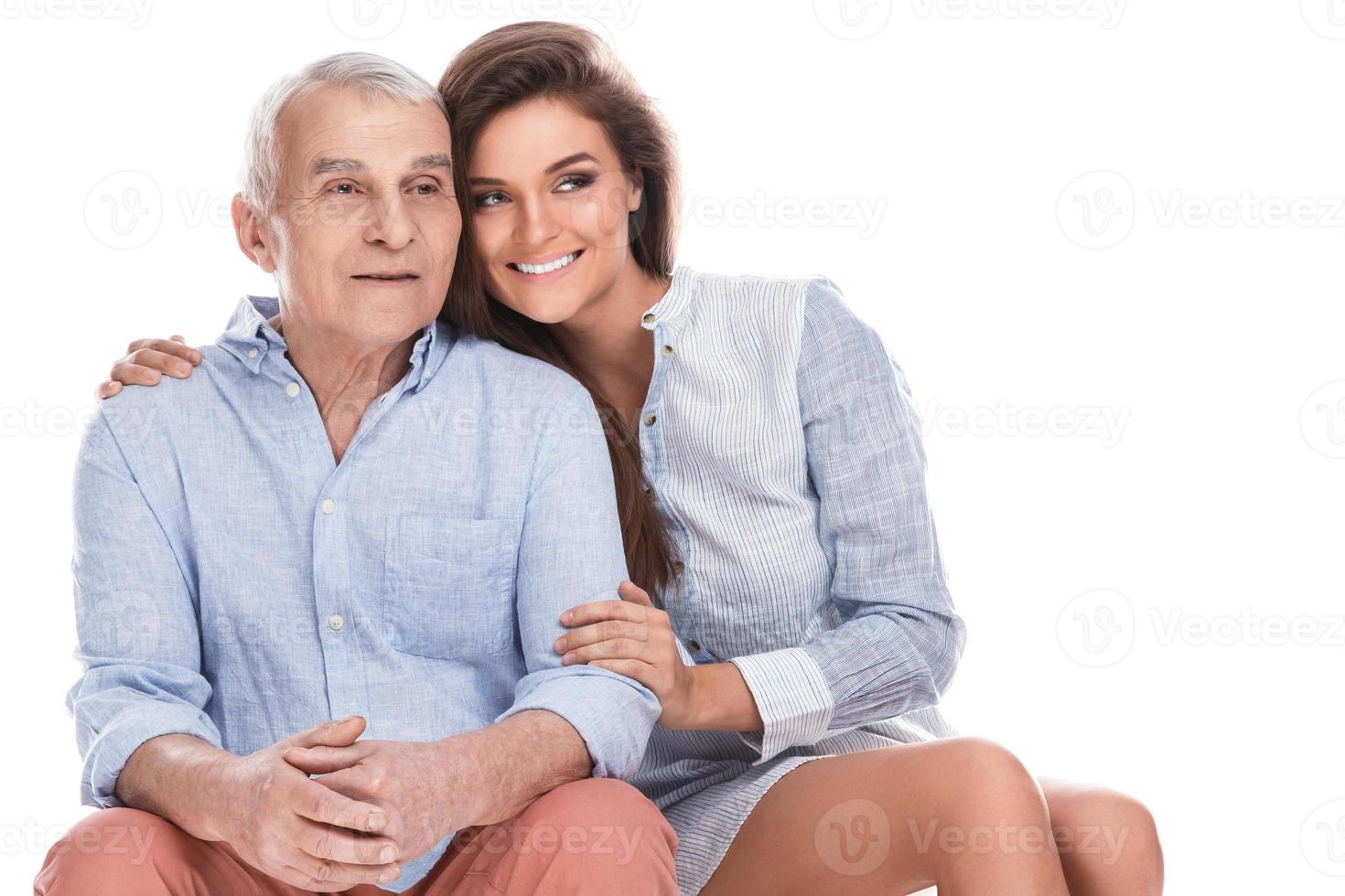 Woman and her eldery father on white background photo