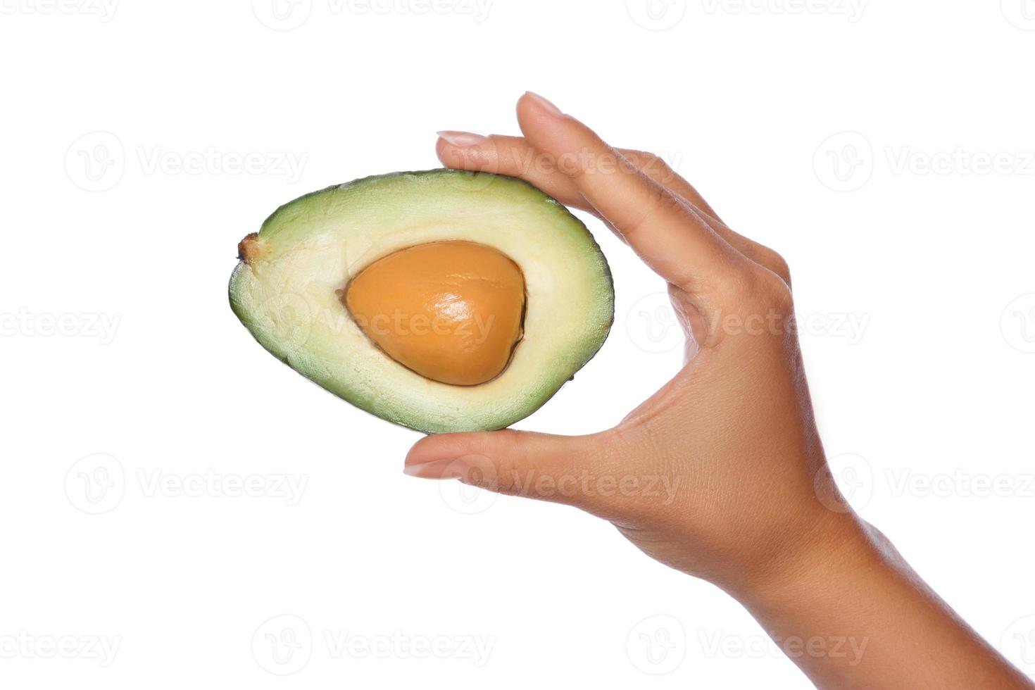 Hand with fresh avocado fruit on white background photo