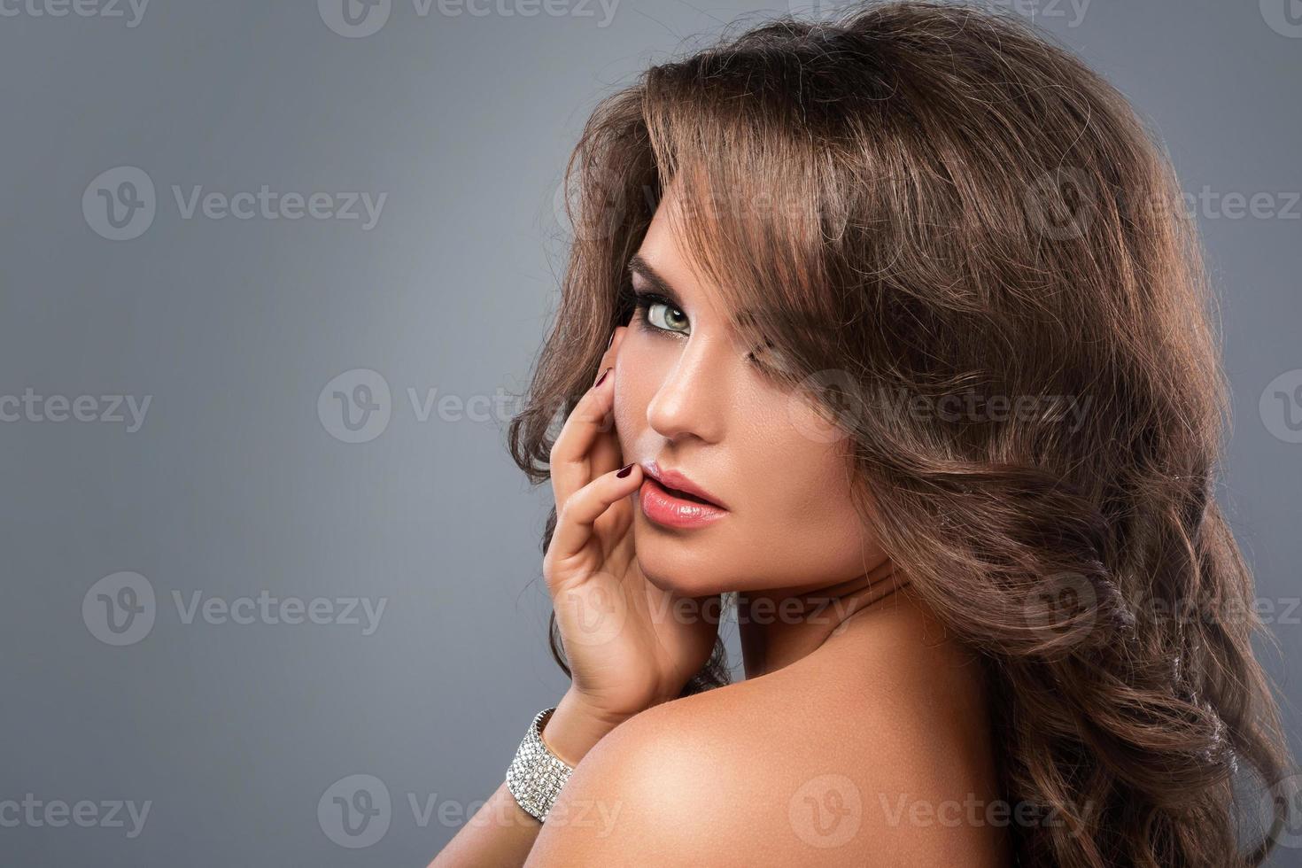 Gorgeous woman with beautiful makeup and hairdo photo