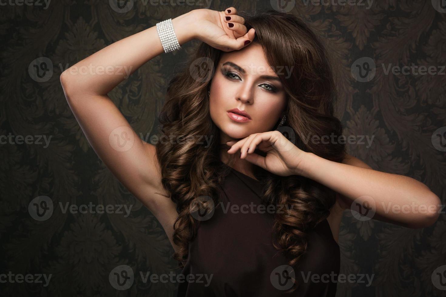 Gorgeous woman with beautiful makeup and hairdo photo