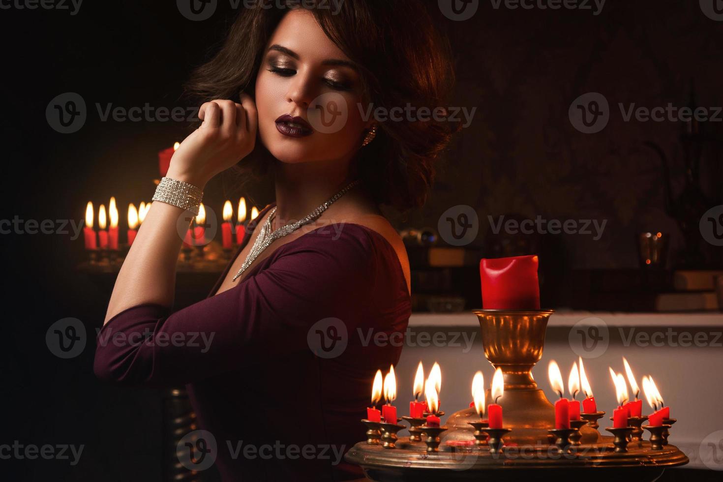 Woman in the room with a lot of candles photo