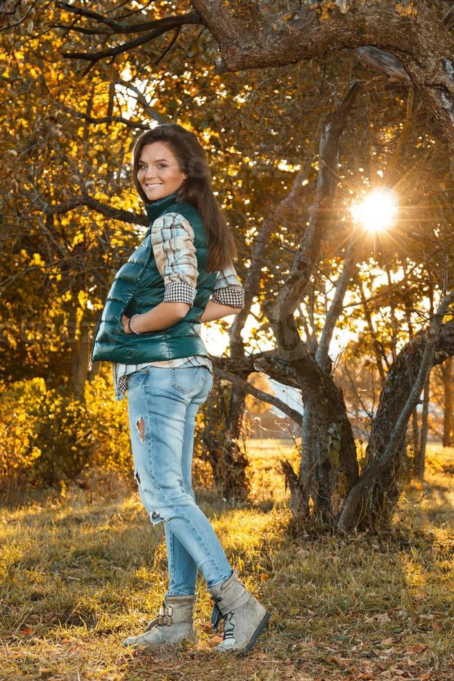 Woman in the park at sunny autumn day photo