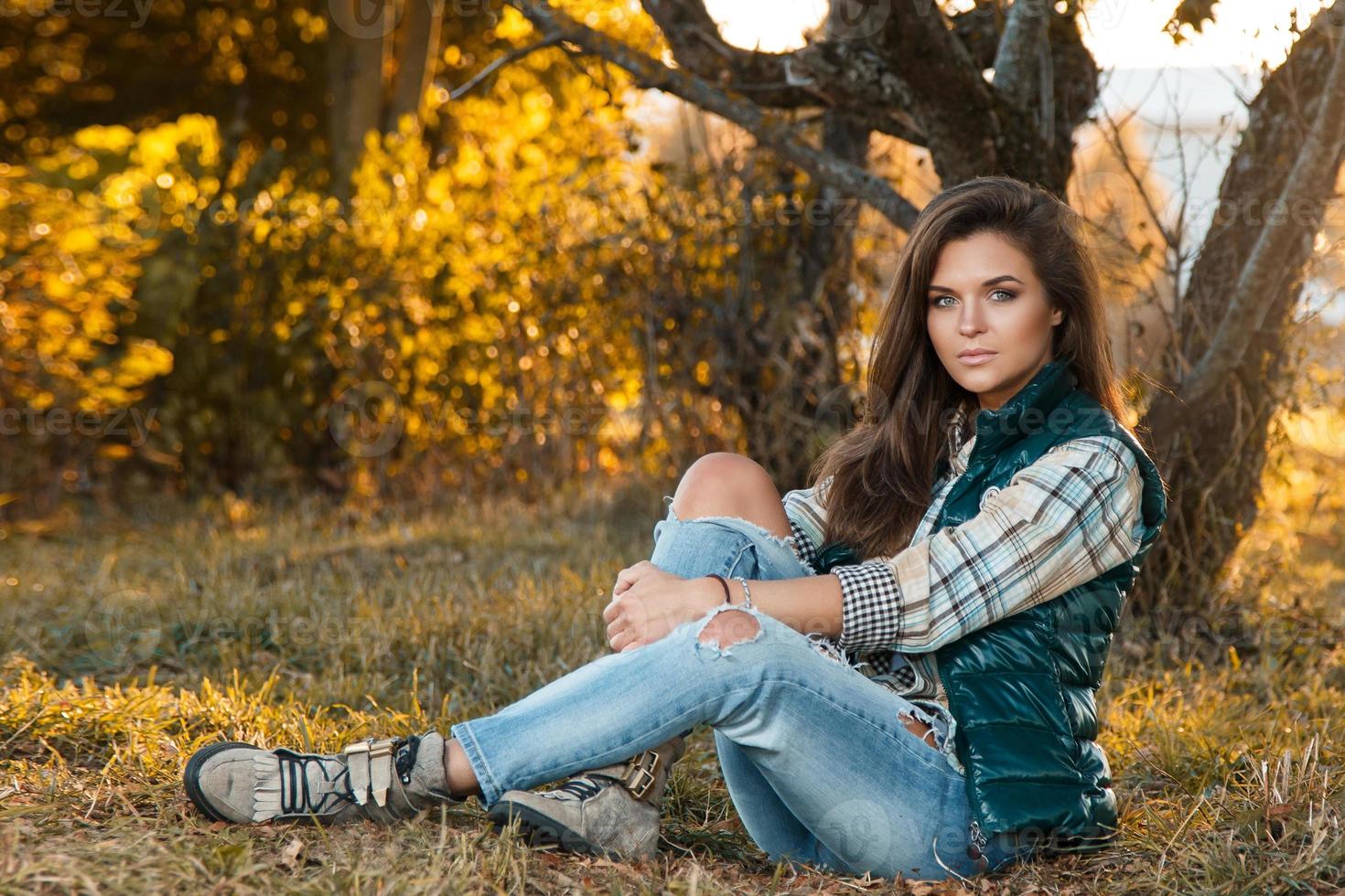 Woman in the park at sunny autumn day photo