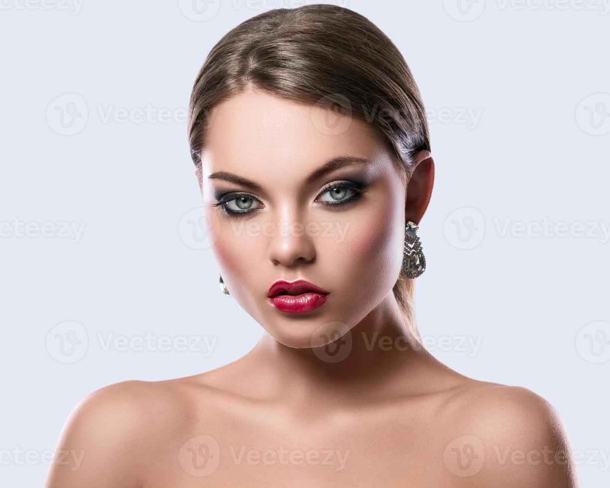 Portrait of young woman with beautiful earrings photo