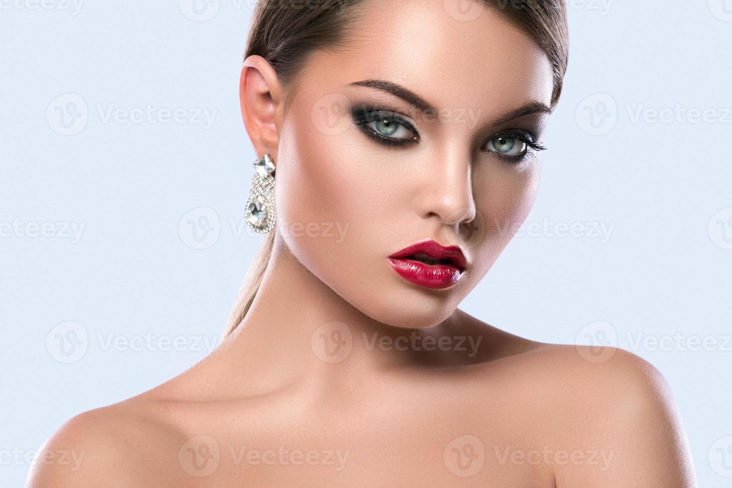 Portrait of young woman with beautiful earrings photo