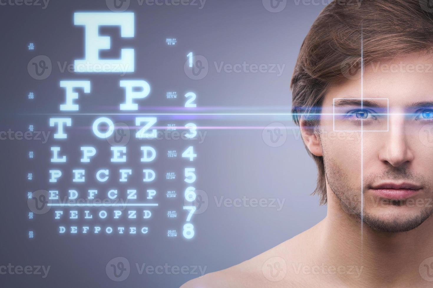 Male face with eye chart. Eyesight and visual acuity concept photo