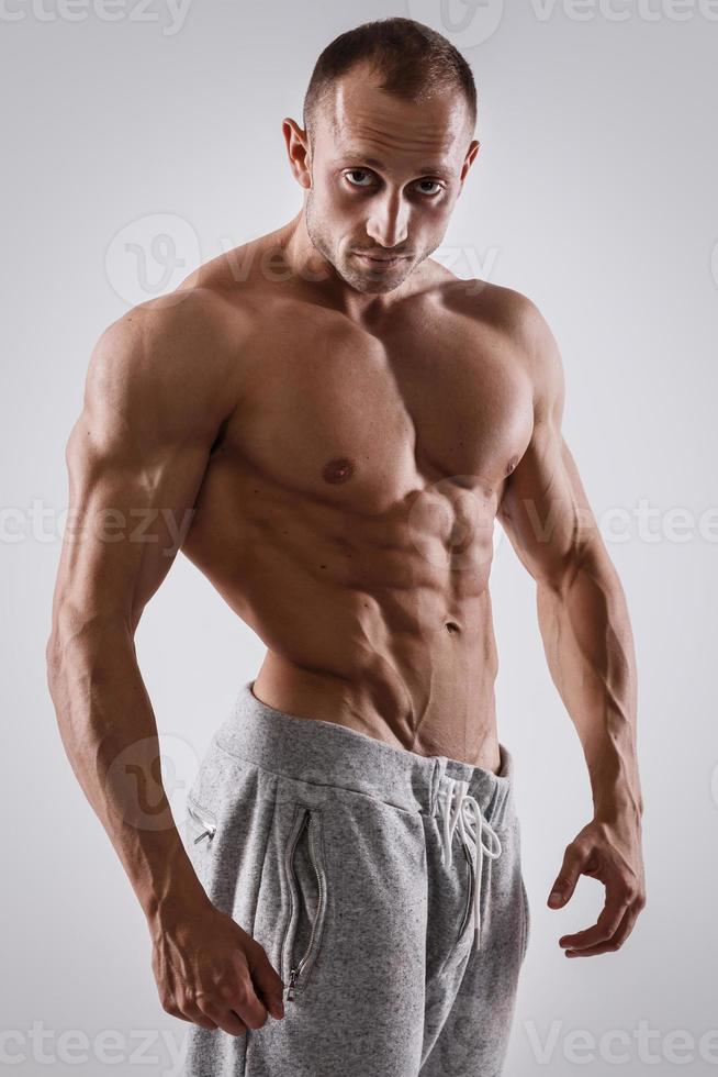 Handsome and muscular man posing in studio photo