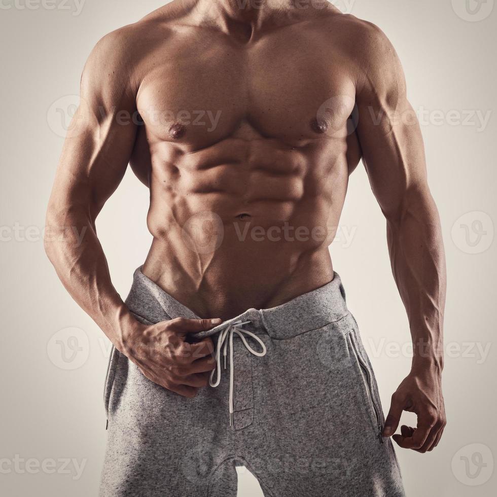 Handsome and muscular man posing in studio photo