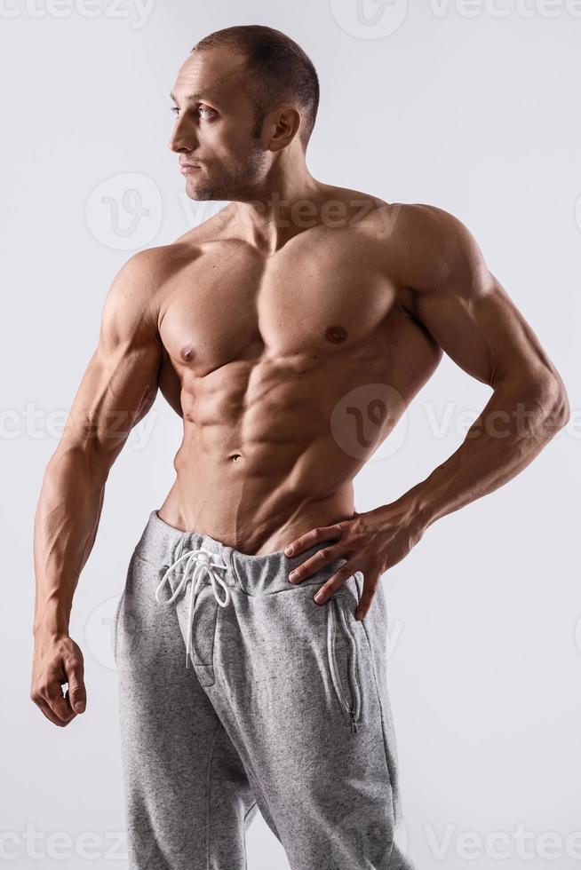 Handsome and muscular man posing in studio photo