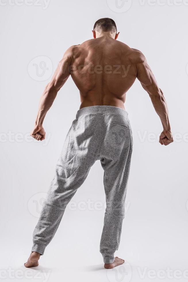 Handsome and muscular man posing in studio photo