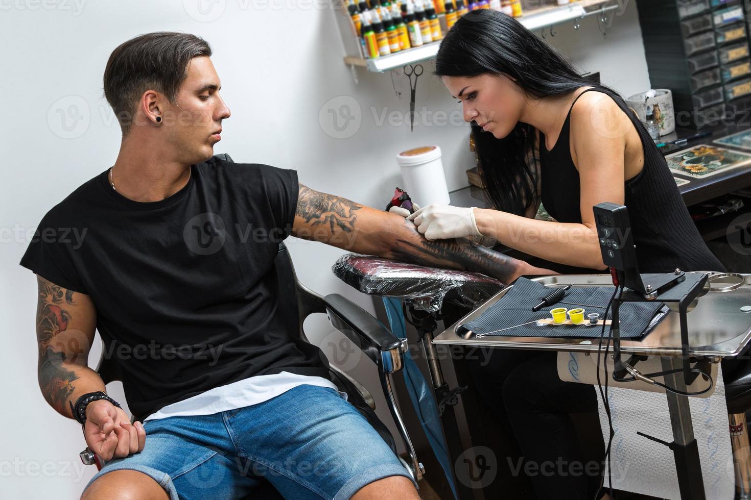 Tattoo artist during her work photo