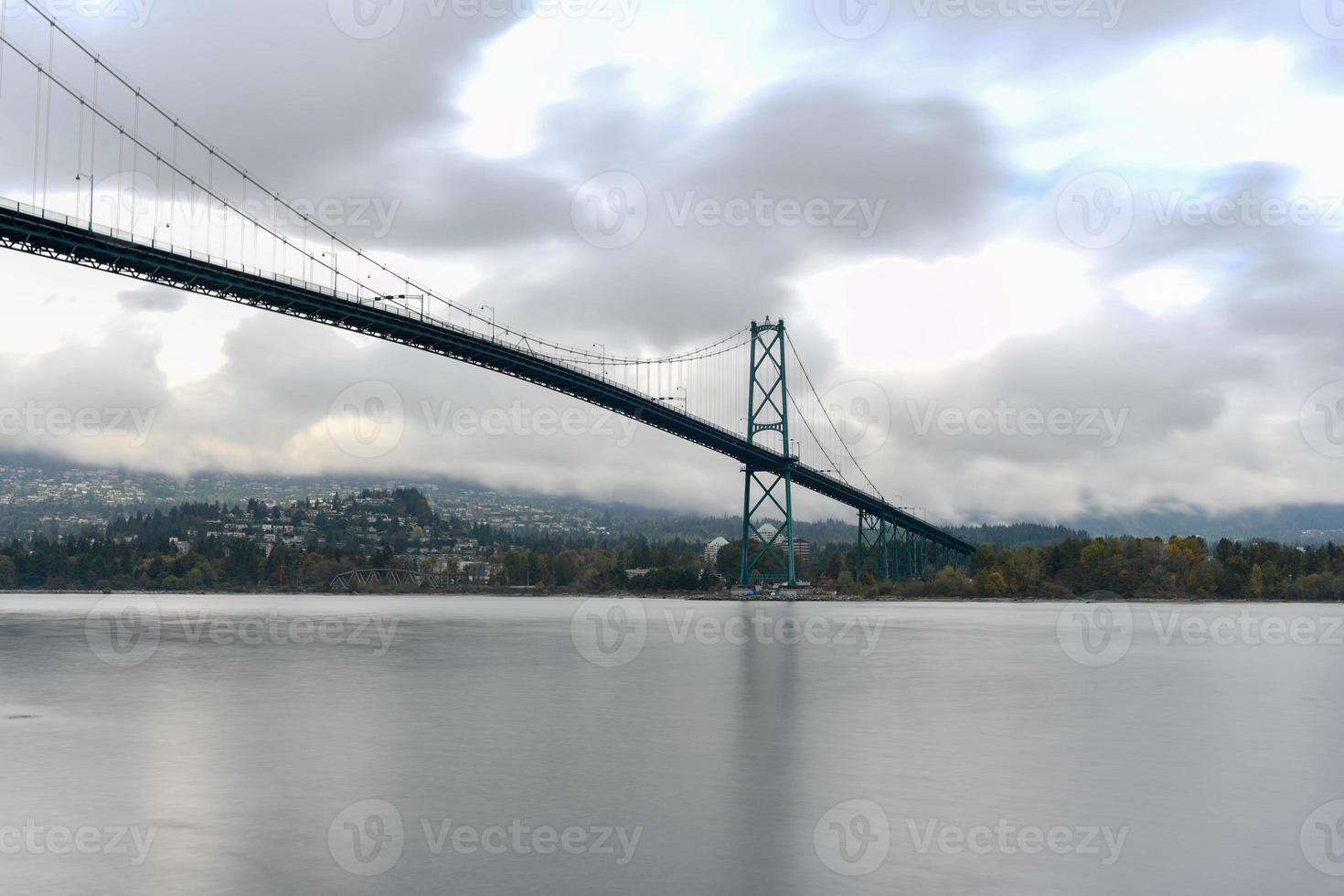 Lions Gate Bridge as seen from Stanley Park in  Vancouver, Canada. The Lions Gate Bridge, opened in 1938, officially known as the First Narrows Bridge, is a suspension bridge. photo