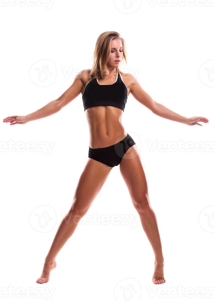 Fitness girl with muscular body posing in studio photo