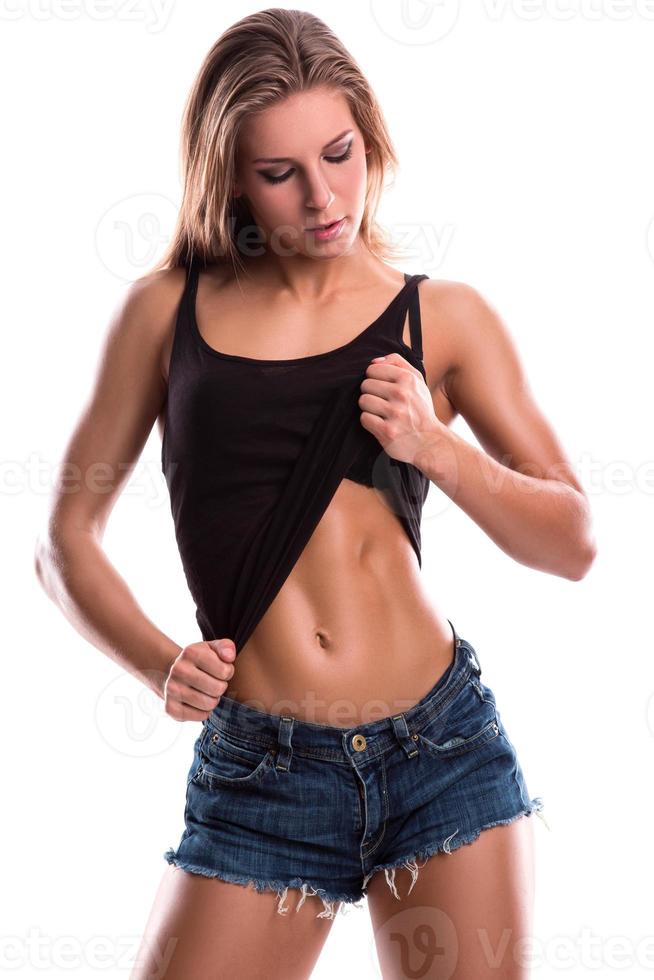 Fitness girl with muscular body posing in studio photo