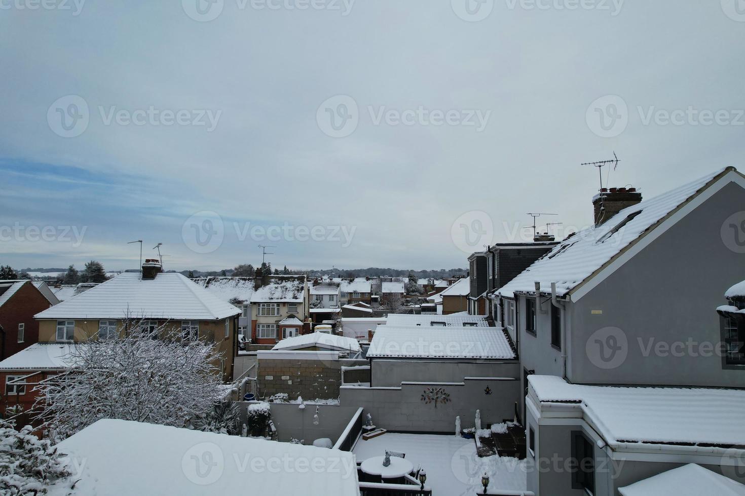 High angle view of Snow covered North Luton's landscape and Cityscape, Aerial Footage of Northern Luton City of England UK after Snow Fall. The 1st Snow Fall of this Winter of 2022 photo