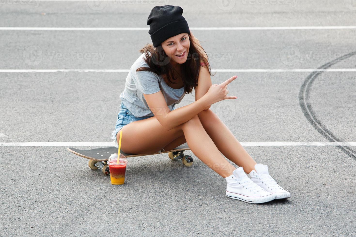 Portrait of beautiful girl with a skateboard photo