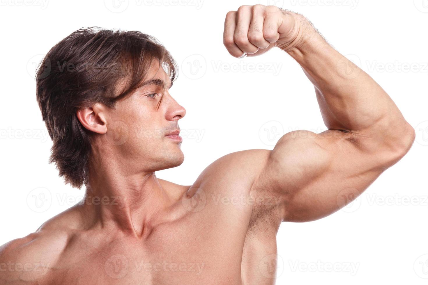 Handsome young muscular man on white background photo