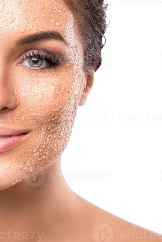 Young beautiful woman with sugar scrub on her face photo