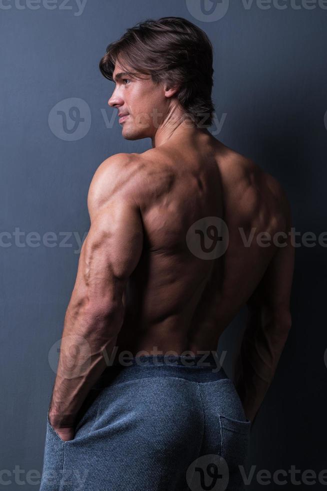 Handsome and muscular man posing in studio photo